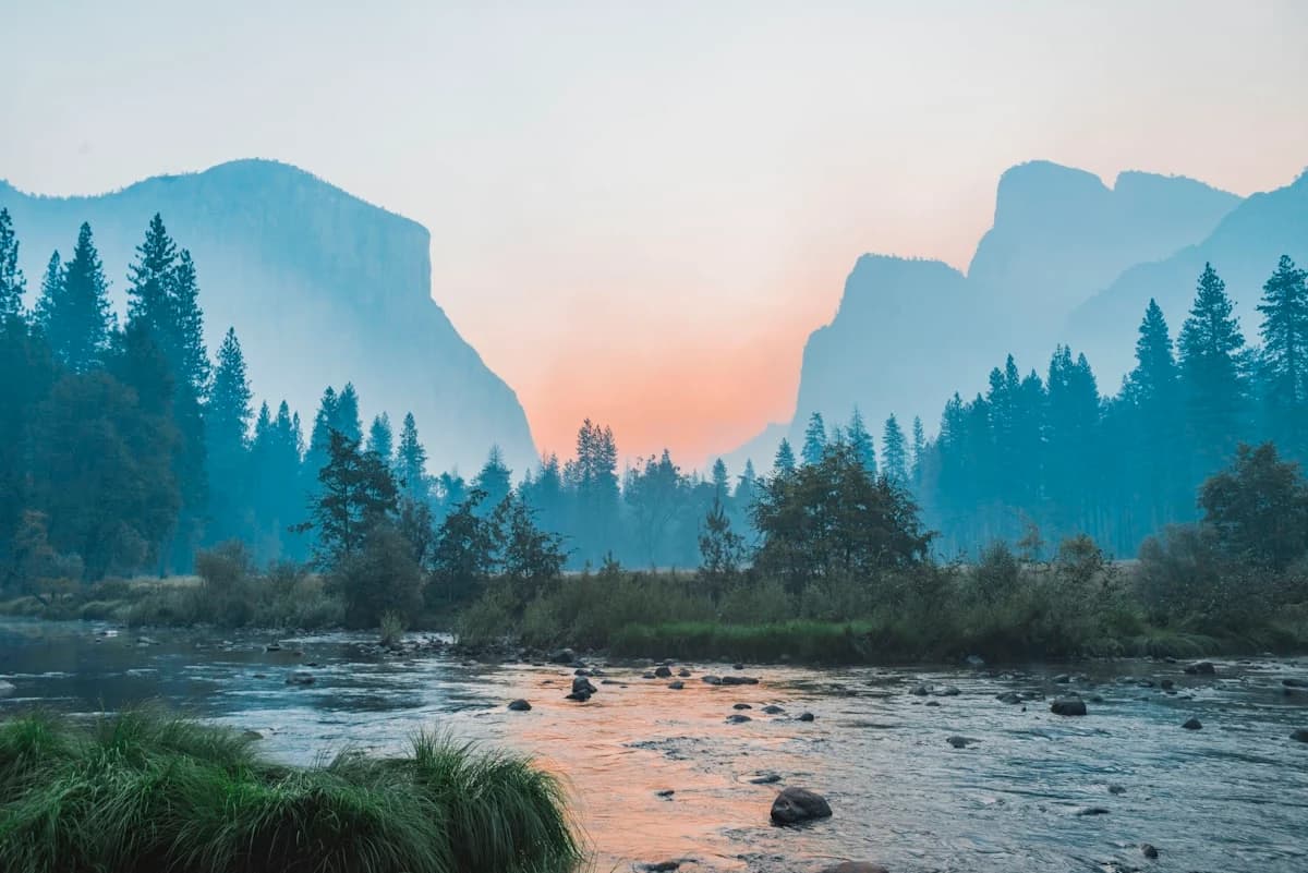 Pale mist settling over a still valley river